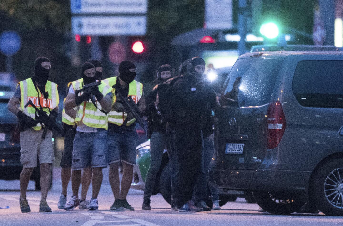 People leave the Olympia mall in Munich after several people were killed in a shooting.