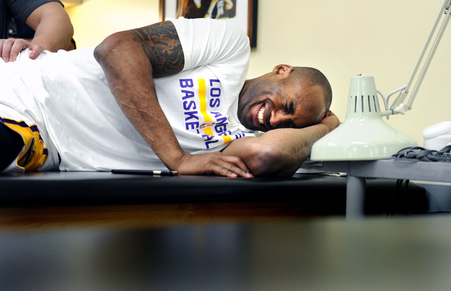 Lakers Kobe Bryant laughs while stretching in the trainers room before a game with the Knicks at the Staples Center.
