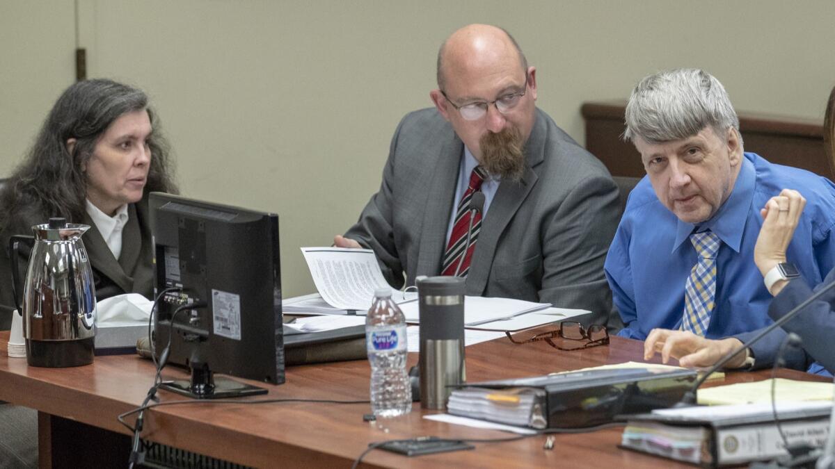 Louise Turpin, left, and her husband, David Turpin, right, will face trial on multiple felony charges related to the torture and abuse of their children, a Riverside County judge ruled Thursday.