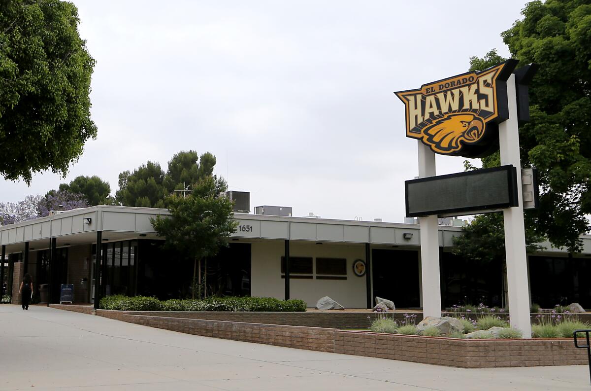 Exterior of El Dorado High School with a marquee that has a sign that reads El Dorado Hawks