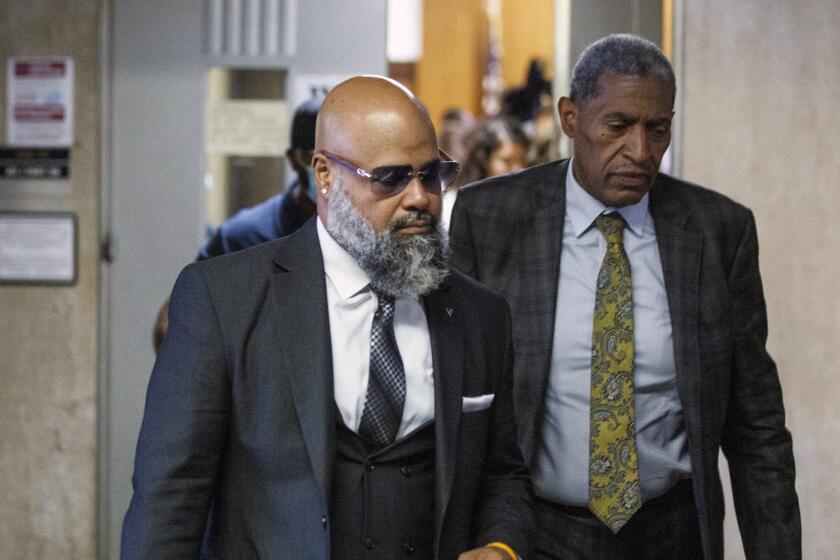 Steven Lopez, left, exits a courtroom, Monday, July 25, 2022, in New York. Lopez, a co-defendant of the so-called Central Park Five, whose convictions in a notorious 1989 rape of a jogger were thrown out more than a decade later, had his conviction on a related charge overturned Monday. (AP Photo/Eduardo Munoz Alvarez)