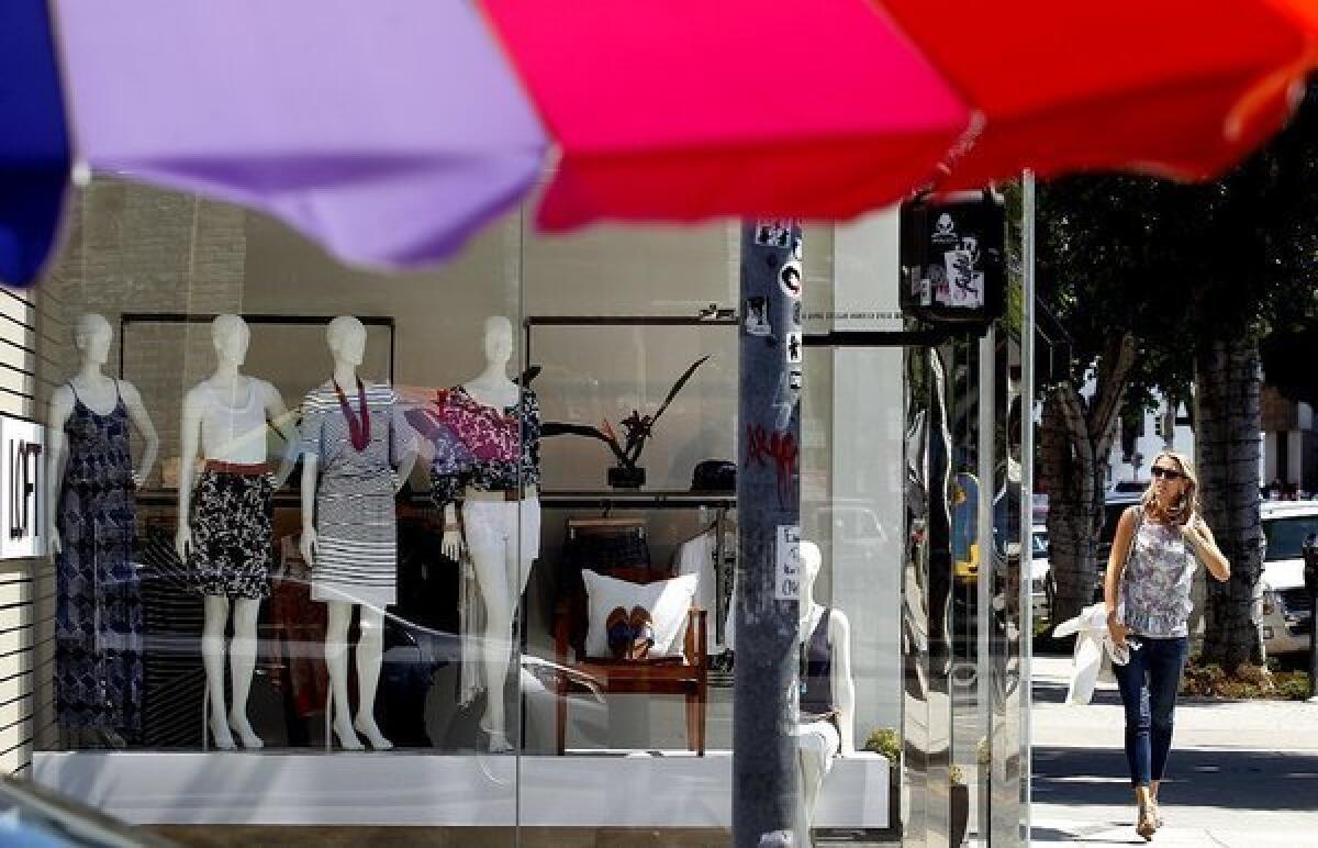 Jelena Trifunovic, right, passes by a store on Robertson Boulevard in Los Angeles.