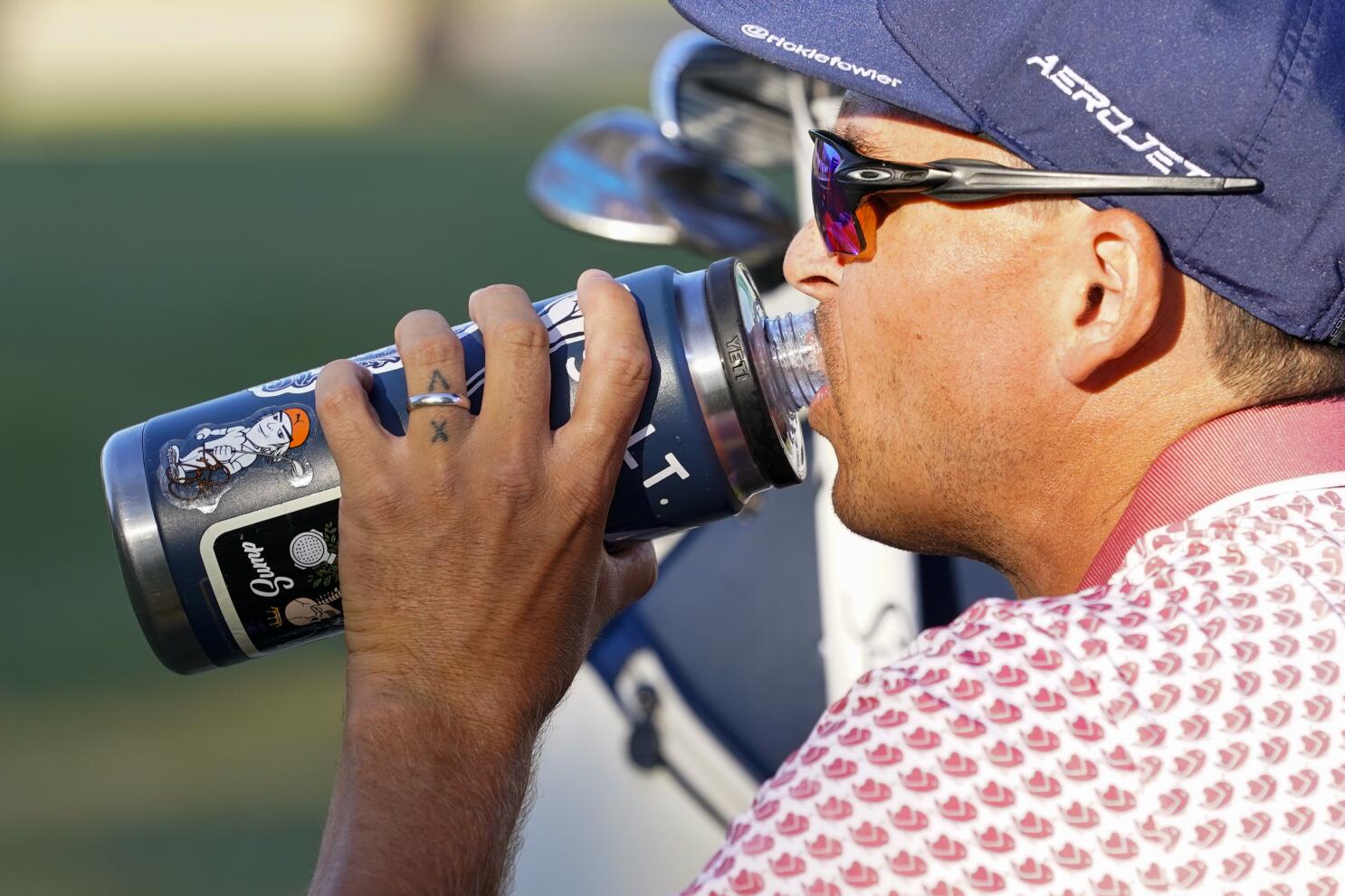 Stickers adorn Rickie Fowler's ever-present water bottle at US Open