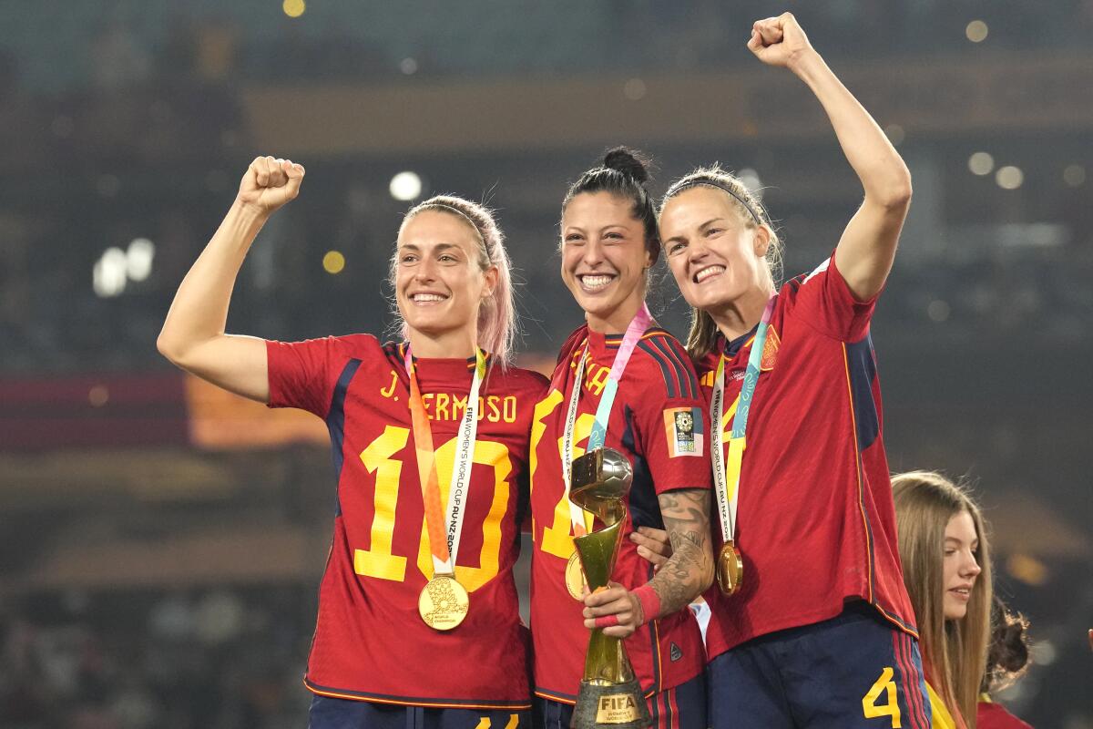 Spain players Alexia Putellas, left, Jenni Hermoso and Irene Paredes celebrate after defeating England.