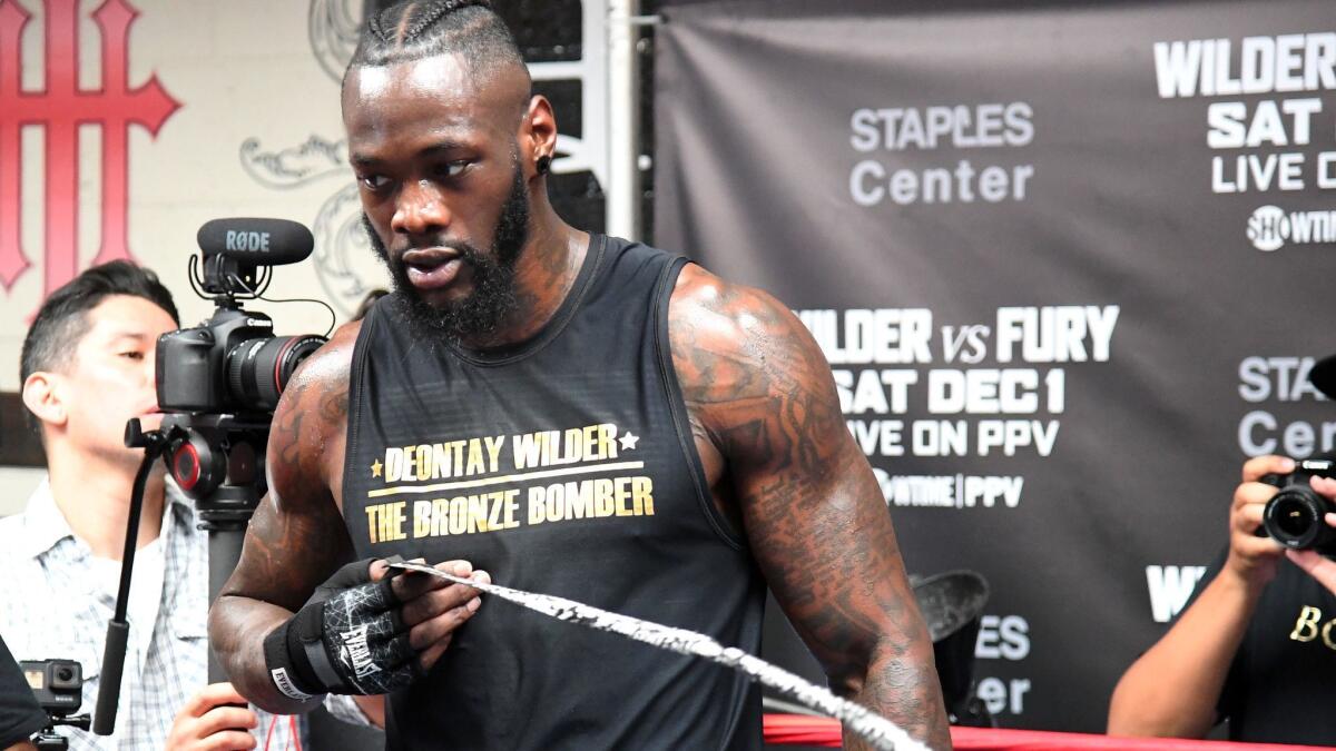 Deontay Wilder removes his hand wraps after a media day workout at Churchill Boxing Club on Nov. 5 in Santa Monica.