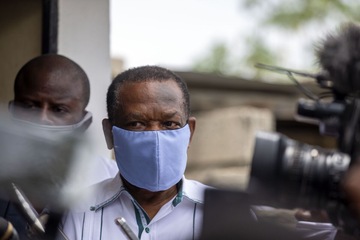 FILE - Yves Jean-Bart, president of the Haitian Football Federation, wearing a protective face mask, arrives for a court hearing regarding allegations that he abused female athletes at the country's national training center, in Croix-des-Bouquets, Haiti, May 21, 2020. Haiti’s former soccer federation president, whose lifetime ban from sport over sexual abuse allegations was overturned in Feb. 2023, announced Wednesday, March 1, 2023 that he is reclaiming his position. (AP Photo/Dieu Nalio Chery, File)