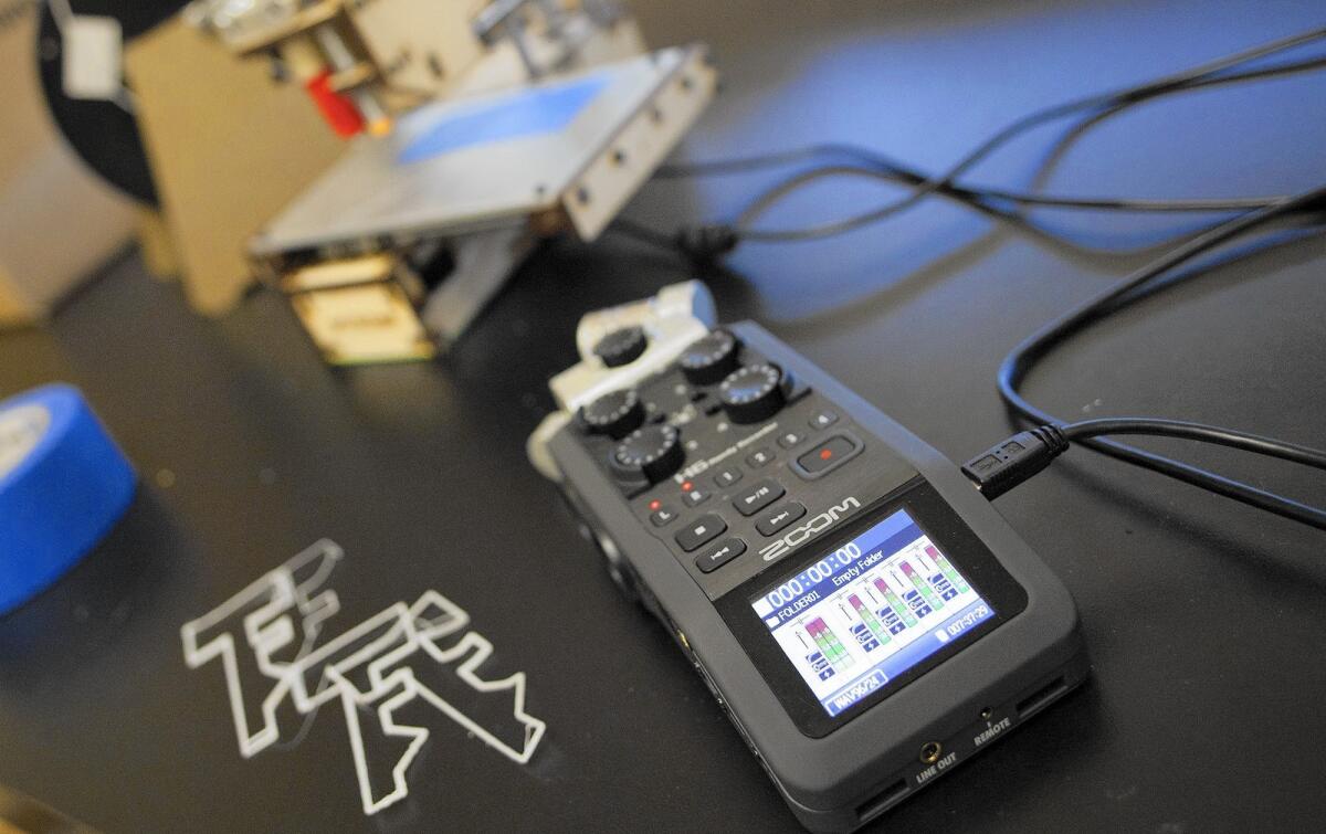 An audio recorder notes sounds emitted by a basic 3-D printer in the Advanced Integrated Cyber-Physical Systems Lab at UC Irvine. At left are printed key shapes.