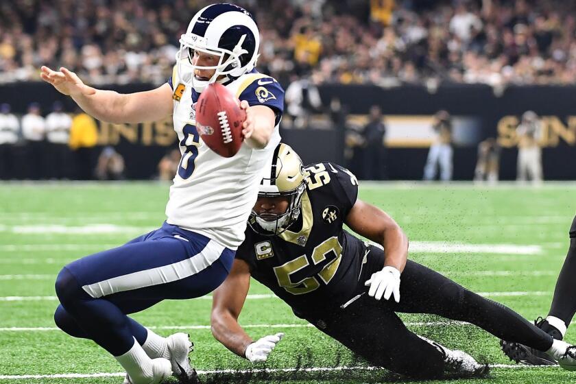 NEW ORLEANS, LOUISIANA, NOVEMBER 4, 2018-Rams place holder Johnny Hekker can't make the 1st down on a fake punt as linebacker Craig Robertson makes the tackle in the 1st quarter at the Mercedes Benz Superdome in Louisiana Sunday. (Wally Skalij/Los Angeles Times)