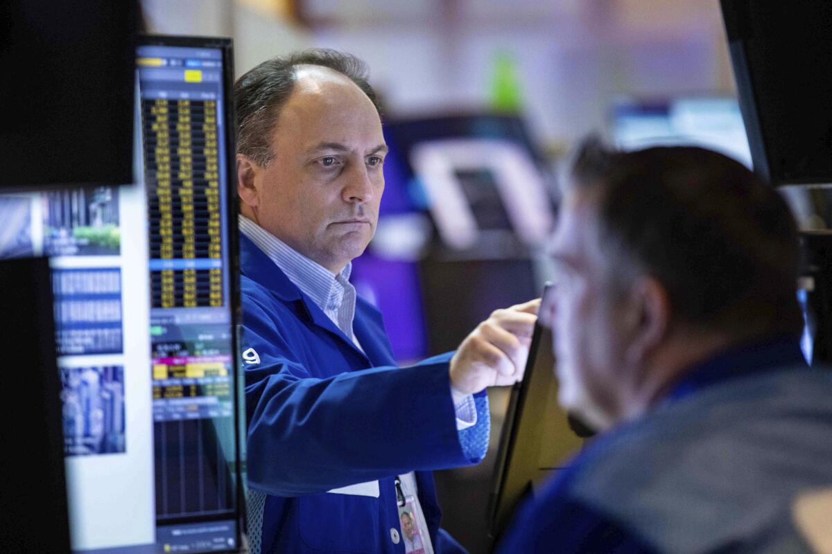 A trader works on the floor of the New York Stock Exchange.