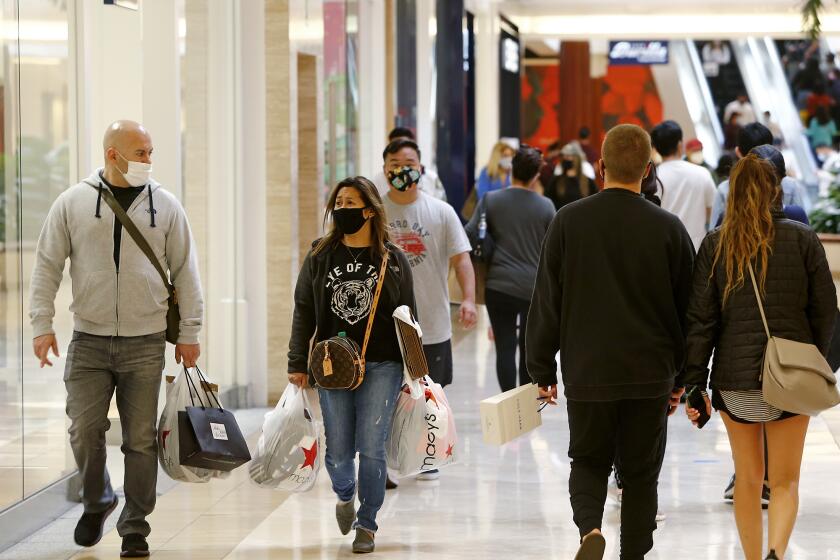 Holiday shoppers at South Coast Plaza in Costa Mesa on Saturday.