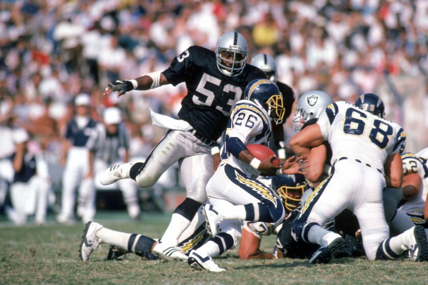 L.A. Raiders linebacker Rod Martin prepares to tackle Chargers running back Lionel James on Sept. 28, 1986, at the Coliseum.