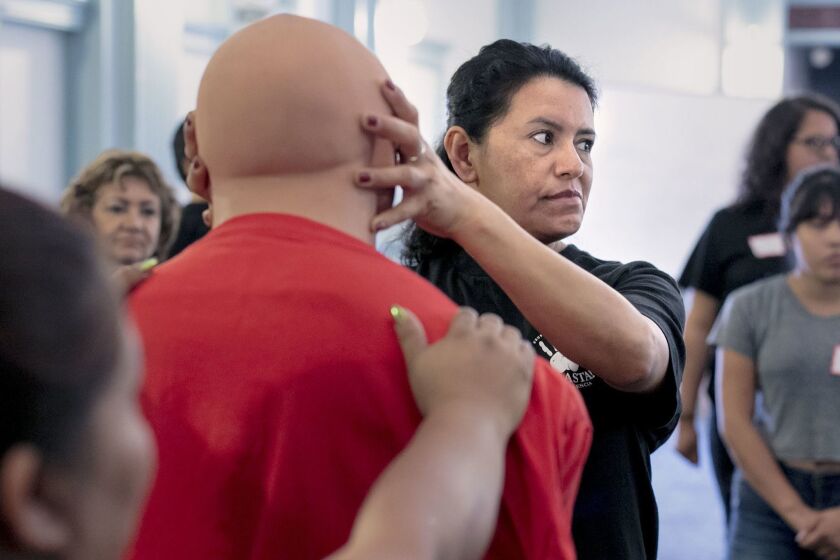 LOS ANGELES, CA - Aug. 25, 2018: Maria Nieto, 42, demonstrates an eye gauge on a male mannequin during a self defense training for janitors on Saturday afternoon, Aug. 25, 2018, at the Maintenance Cooperation Trust Fund building in downtown Los Angeles. The state-wide watchdog organization has been training women since January 2018 and has so far had 100 women attend their classes. (Silvia Razgova / For The Times)