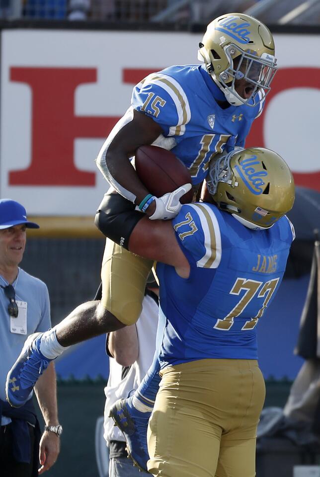 UCLA running back Martell Irby celebrates with lineman Andre James after scoring a touchdown against Stanford during the third quarter.