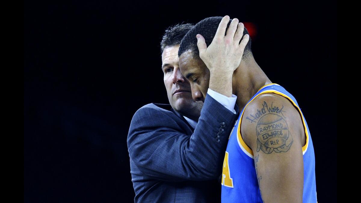UCLA Coach Steve Alford consoles guard Norman Powell near the end of the game against Gonzaga in the NCAA tournament's South Regional semifinals on Friday night in Houston.