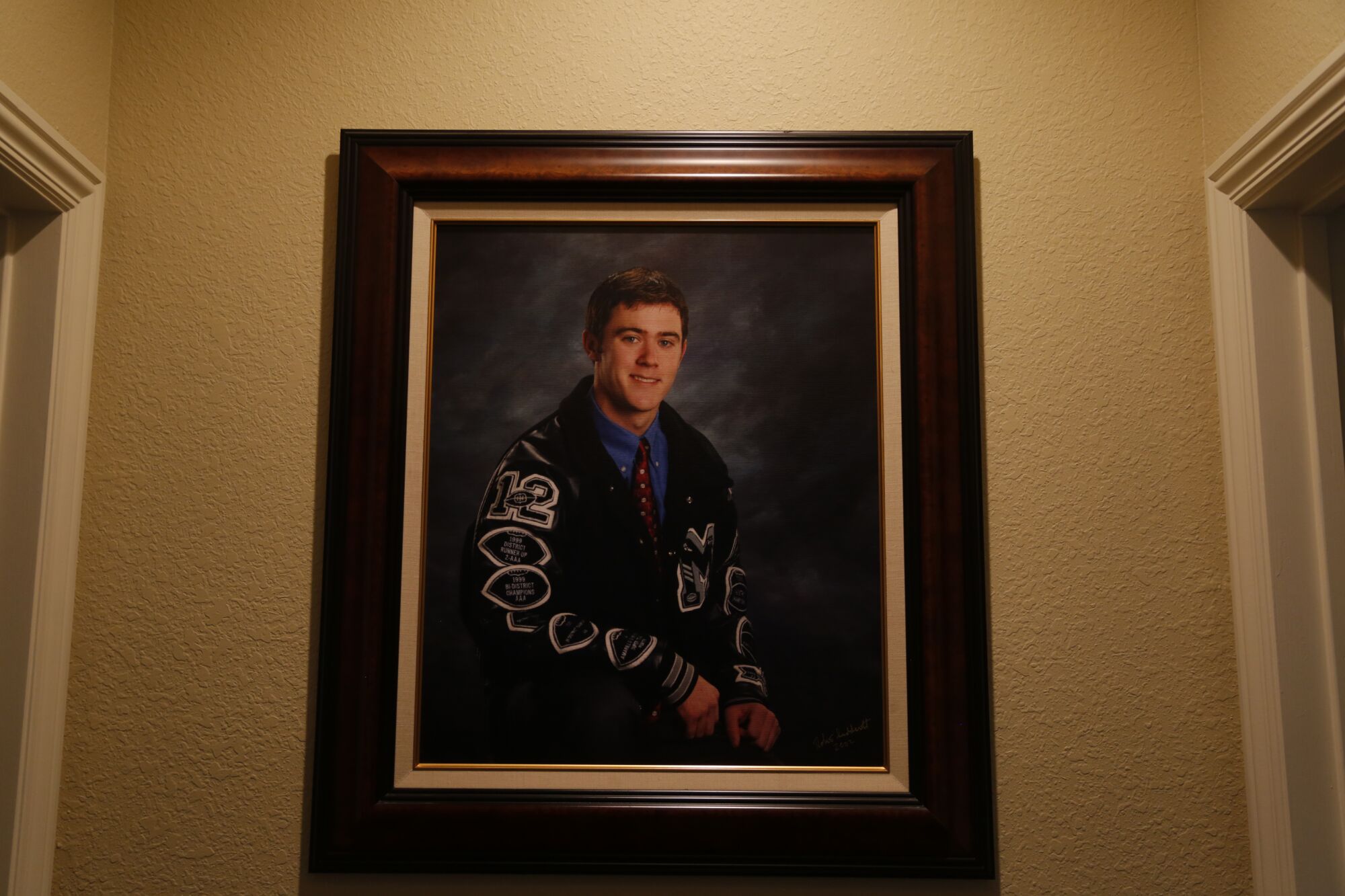 A high school portrait of USC coach Lincoln Riley hangs on the wall of his parent's home in Muleshoe, Texas