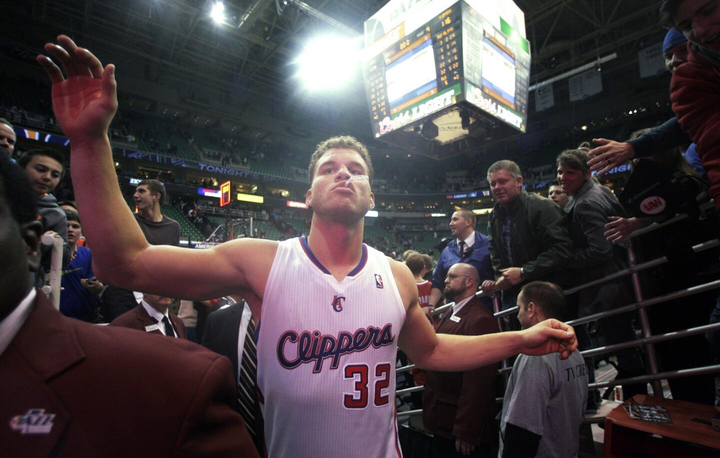 Clippers power forward Blake Griffin gives fives to fans as he exits the court after a 116-114 victory over the Jazz on Friday night in Utah.