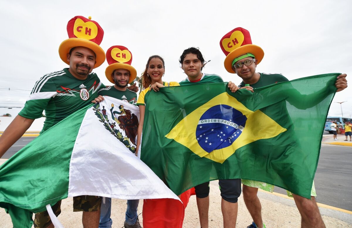 Mexico and Brazil fans show support before the 2014 FIFA World Cup Brazil Group A match between Brazil and Mexico at Castelao on Tuesday.