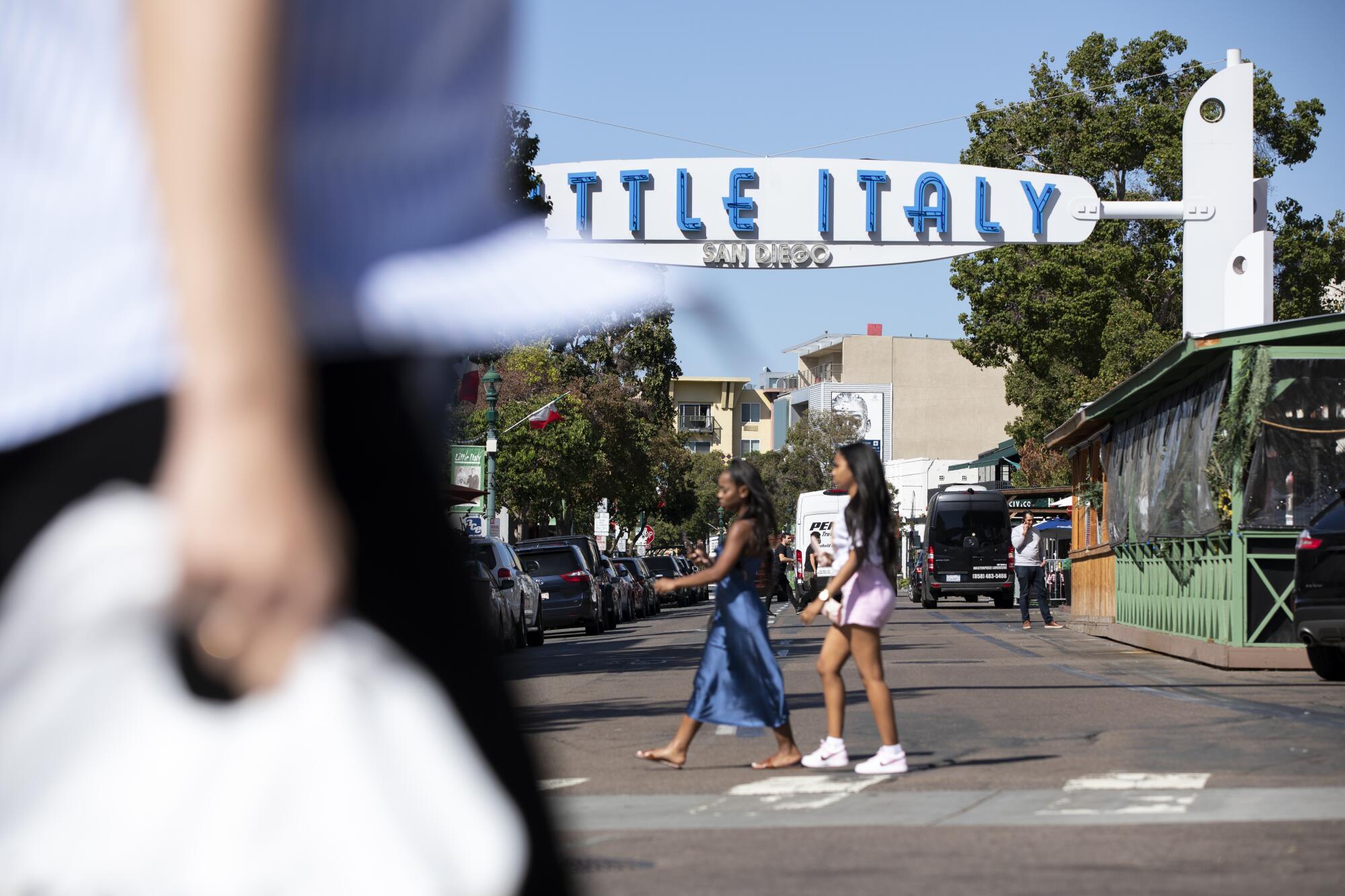 People stroll in Little Italy on Tuesday, Oct. 19, 2021 in San Diego, California.