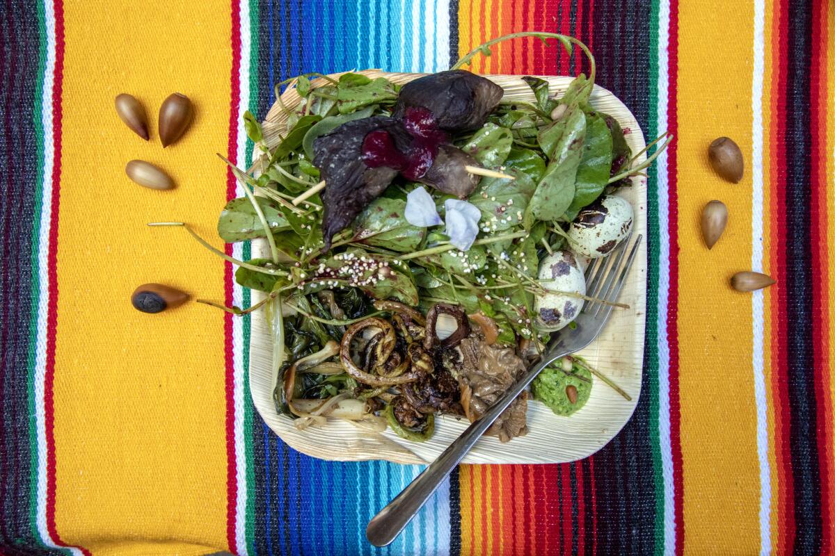 Maarah salad (quail eggs, fiddleheads, Indian onion, watercress pesto, yellowfoot mushrooms, smoked venison skewers, blackberry coulis) served at Cafe Ohlone.