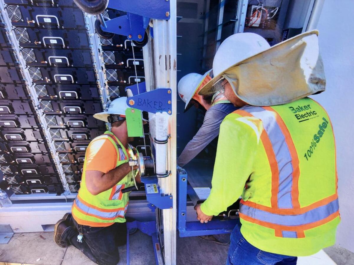 Three men in helmets and reflective vests at work.