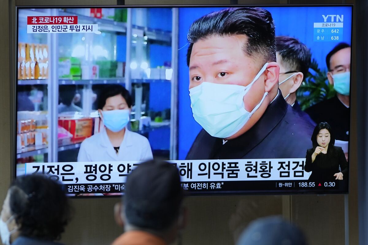 FILE - People watch a TV screen showing a news program reporting with an image of North Korean leader Kim Jong Un, at a train station in Seoul, South Korea on May 16, 2022. As an illness suspected to be COVID-19 sickens hundreds of thousands of his people, Kim stands at a critical crossroad. Does he swallow his pride and accept help or does he go it alone even though a huge number of fatalities could undermine his leadership? (AP Photo/Lee Jin-man, File)