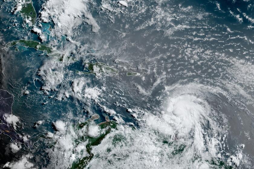 This satellite image provided by the National Oceanic and Atmospheric Administration shows Hurricane Elsa moving through the Caribbean, over Barbados, Tuesday, July 2, 2021, at 12:00 Z (8am a.m. ET). Elsa was expected to pass near the southern coast of Hispaniola on Saturday and to move near Jamaica and portions of eastern Cuba on Sunday. (NOAA/NESDIS/STAR GOES via AP)