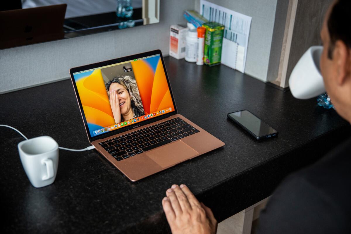 A man talks with his wife via Facetime.