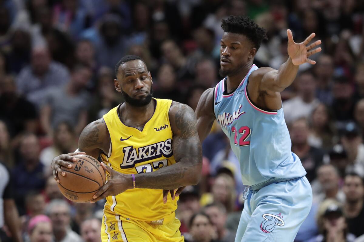 The Lakers' LeBron James takes on the Heat's Jimmy Butler on Dec. 13 in Miami. 