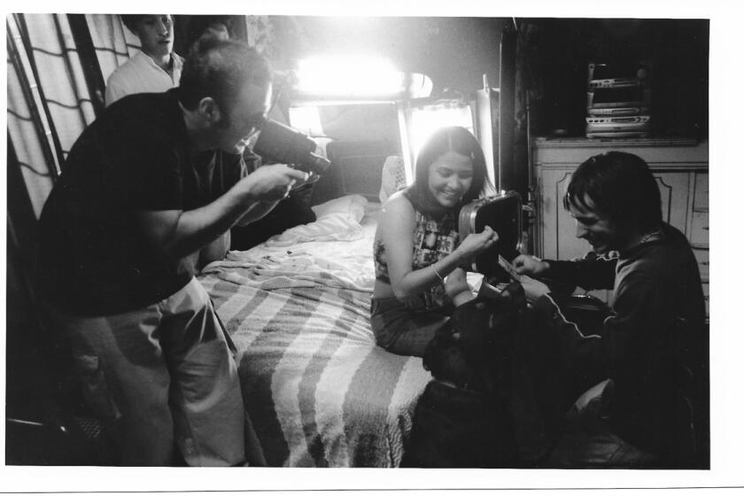A behind the scenes look from the 2000 film 'Amores Perros" directed by Alejandro Gonzalez Inarritu. Pictured: Inarritu with actors Vanessa Bauche and Gael Garcia Bernal.