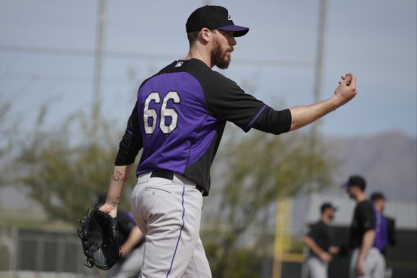 Colorado pitcher John Axford participates in a drill during spring training Feb. 21 in Scottsdale, Ariz.