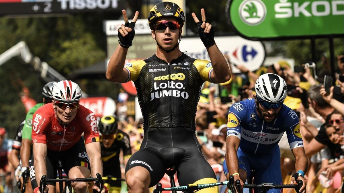 Dylan Groenewegen celebrates as he crosses the finish to win Stage 8 of the Tour de France on Saturday.