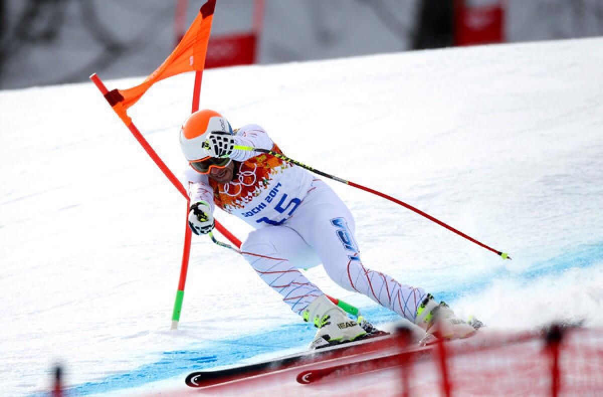 American skier Bode Miller hits a gate during his Sochi Olympics downhill run Sunday at Rosa Khutor Alpine Center.