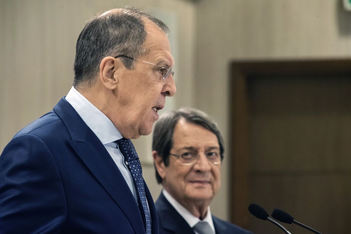 Russian Foreign Minister Sergey Lavrov, left, talks as the Cypriot President Nikos Anastasiades looks on prior to their meeting at the presidential palace in Nicosia, Cyprus, Tuesday, Sept. 8, 2020. Lavrov is paying an official visit to Cyprus amid heightened tensions over Turkey's search for energy resources in east Mediterranean waters where Greece and Cyprus claim as having exclusive economic rights. (Iakovos Hadjistavrou/Pool Photo via AP)