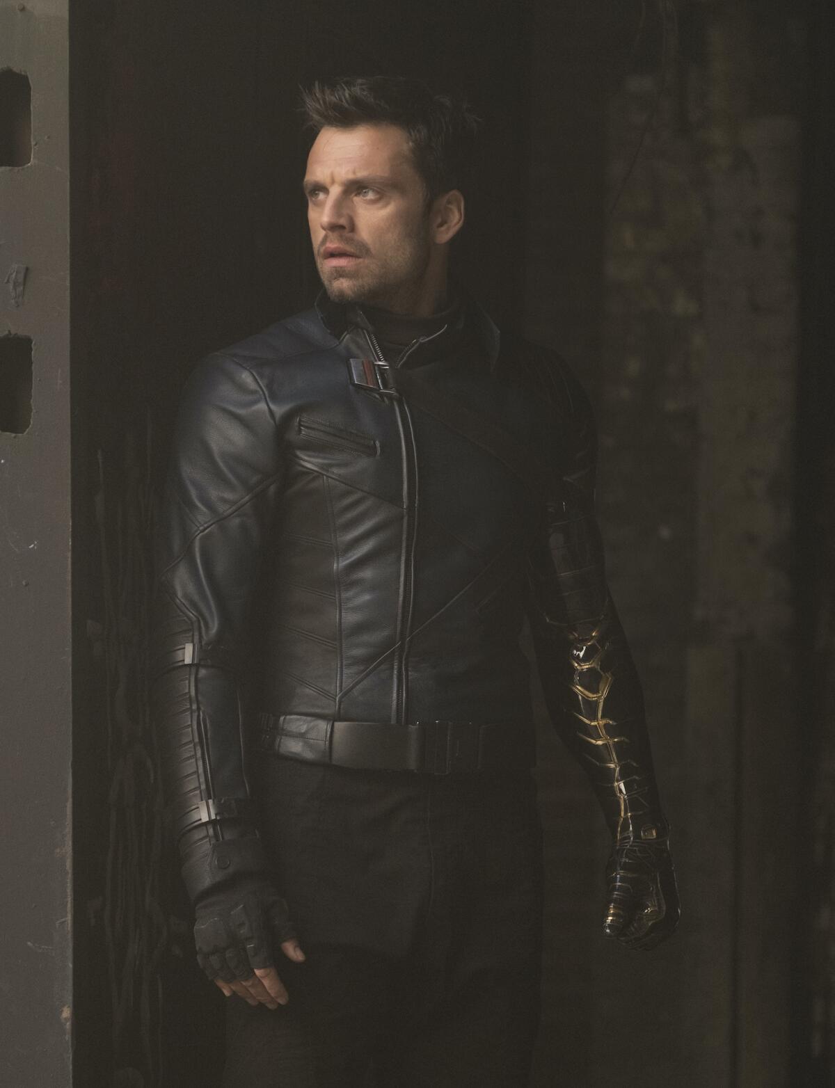 A man in a leather jacket and gloves