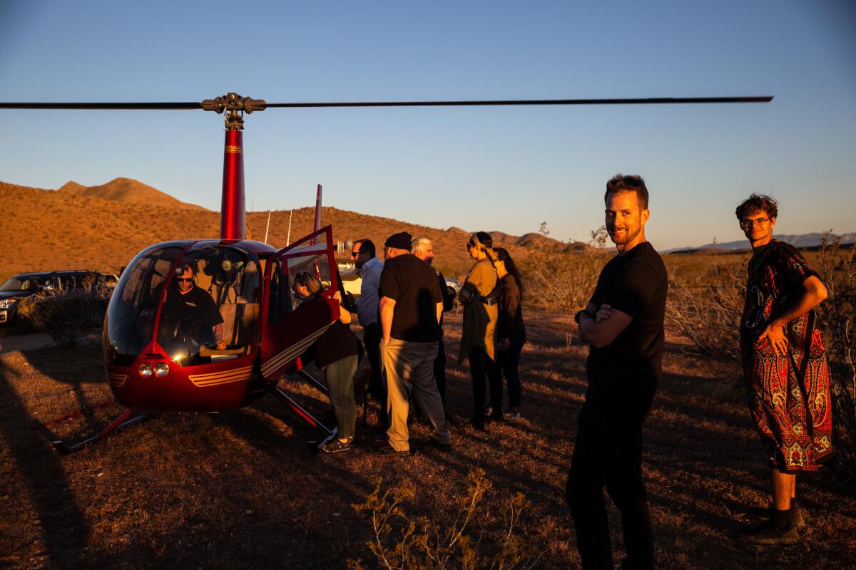 People invited to the Betaspace party wait their turn to catch a ride on the helicopter.