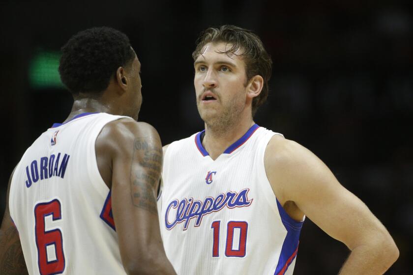 Spencer Hawes, right, talks to Clippers teammate DeAndre Jordan during a game against Portland.