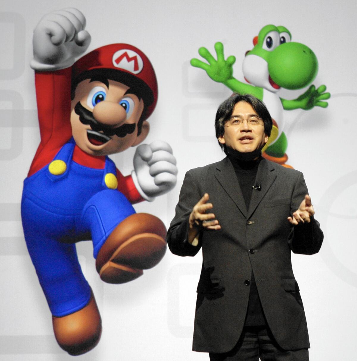 In this July 15, 2008, photo, Satoru Iwata spoke about Nintendo's enhanced Wii remote controller and new games.
