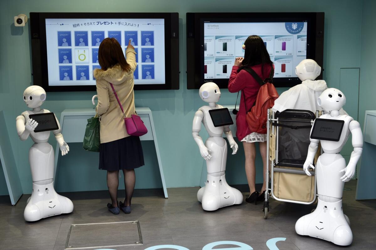 Two women visit a newly opened robot-staffed store run by telecommunications and mobile phone carrier SoftBank Corp. in Tokyo, Japan on March 24.