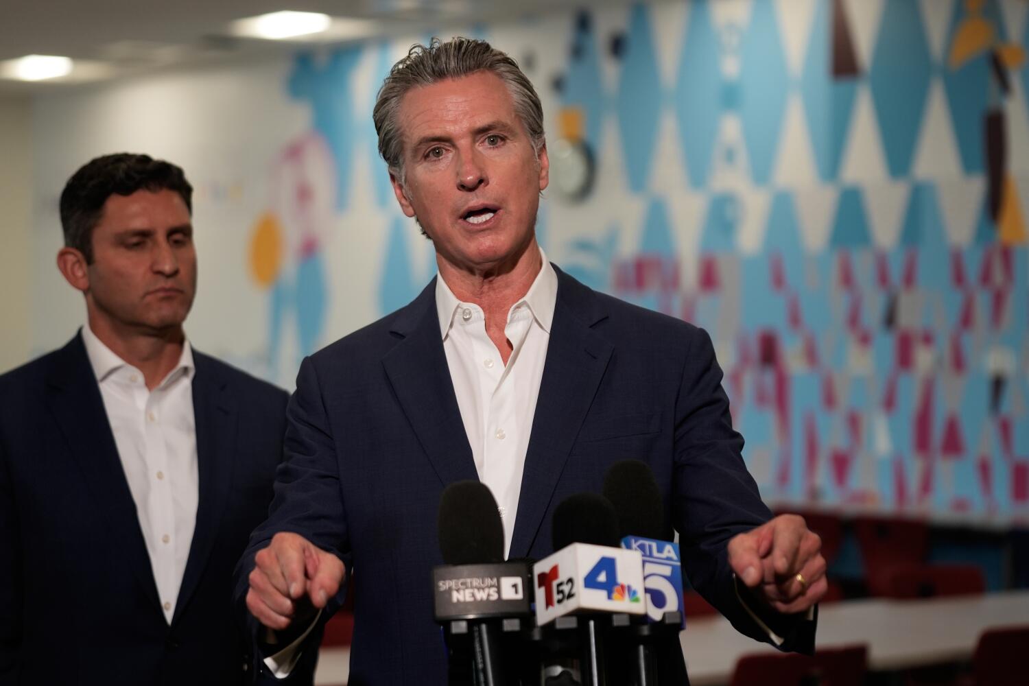 California Gov. Gavin Newsom speaks in front of Democratic Assembly member Jesse Gabriel at a news conference at Belvedere Middle School, Wednesday, Oct. 8, 2025, in Los Angeles. (AP Photo/Damian Dovarganes)