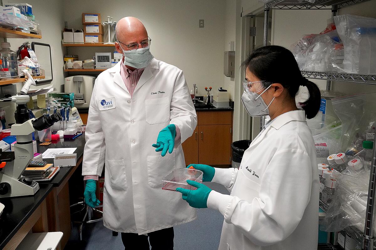 Scientists Chris Parks and Maoli Yuan of the International AIDS Vaccine Initiative discuss their work on a COVID-19 vaccine.