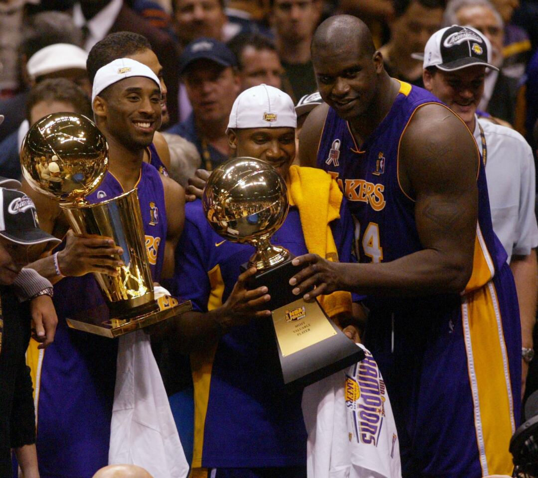 Lakers Kobe Bryant, left, Lindsey Hunter and Shaquille O'Neal just after winning the NBA tile in 2002.
