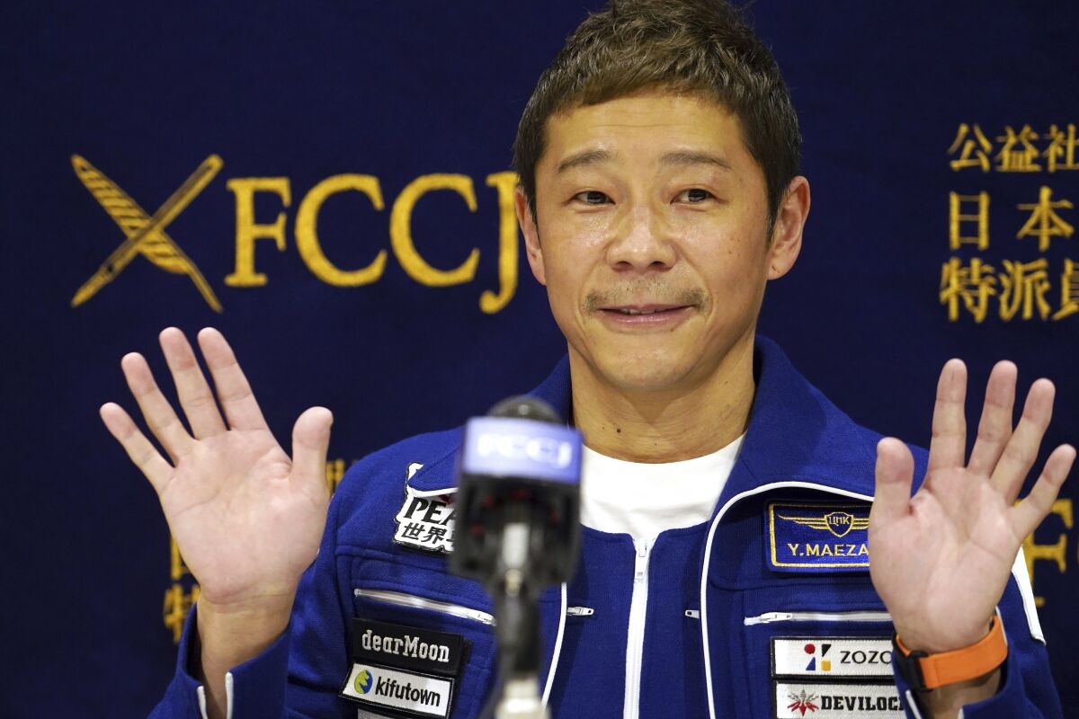 Japanese billionaire Yusaku Maezawa waves during a press conference at the Foreign Correspondents’ Club in Tokyo Friday, Jan. 7, 2022. Maezawa has returned from space with hopes of new celestial investments. (AP Photo/Eugene Hoshiko)