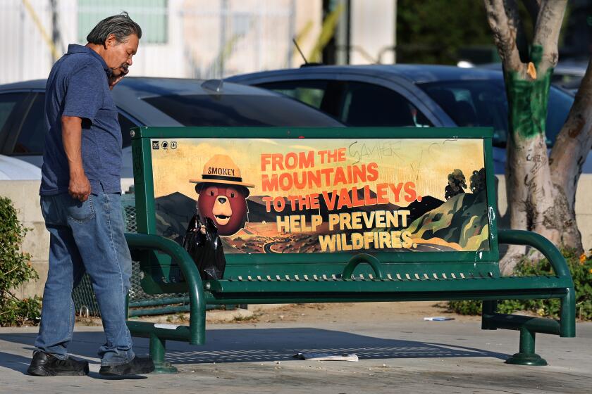 NORTH HOLLYWOOD, CA -SEPTEMBER 1, 2022: A man waits at a Metro bus stop with no shade on Lankershim Blvd. in North Hollywood. The city is about to contract for new shade and there's a big push among activists to do better. (Mel Melcon / Los Angeles Times)