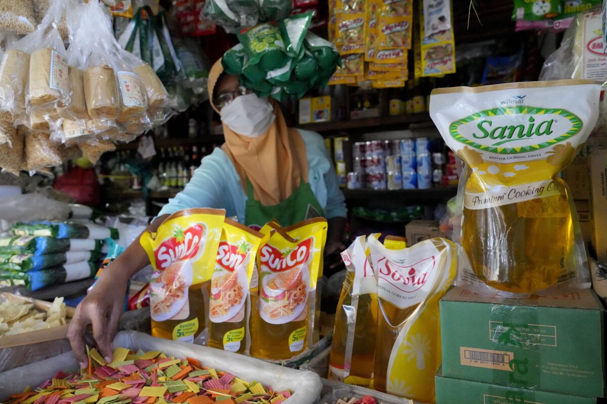 FILE - Packs of palm cooking oil are displayed at a stall at market in Jakarta, Indonesia, Sunday, April 17, 2022. Indonesia said Thursday, May 19, 2022, that it will lift a monthlong ban on palm oil export, citing improvements in the supply and domestic price of bulk cooking oil. (AP Photo/Achmad Ibrahim, File)