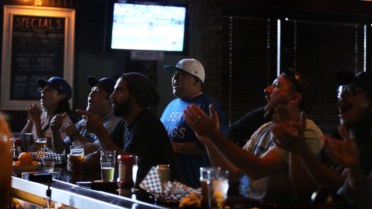 Fans enjoy a game and beers inside the Greyhound Bar & Grill in Los Angeles. (Rick Loomis / Los Angeles Times)
