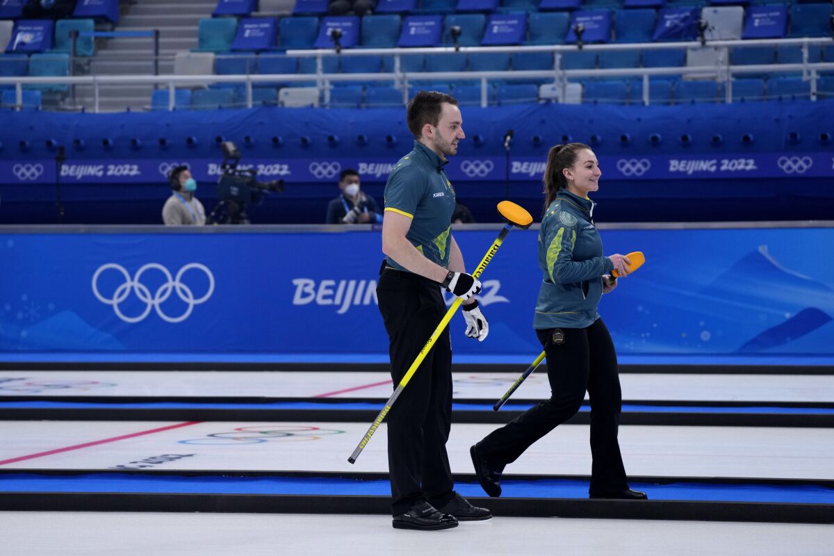 Australia's Tahli Gill and Dean Hewitt, compete during the mixed doubles curling match against Switzerland, at the 2022 Winter Olympics, Sunday, Feb. 6, 2022, in Beijing. (AP Photo/Nariman El-Mofty)