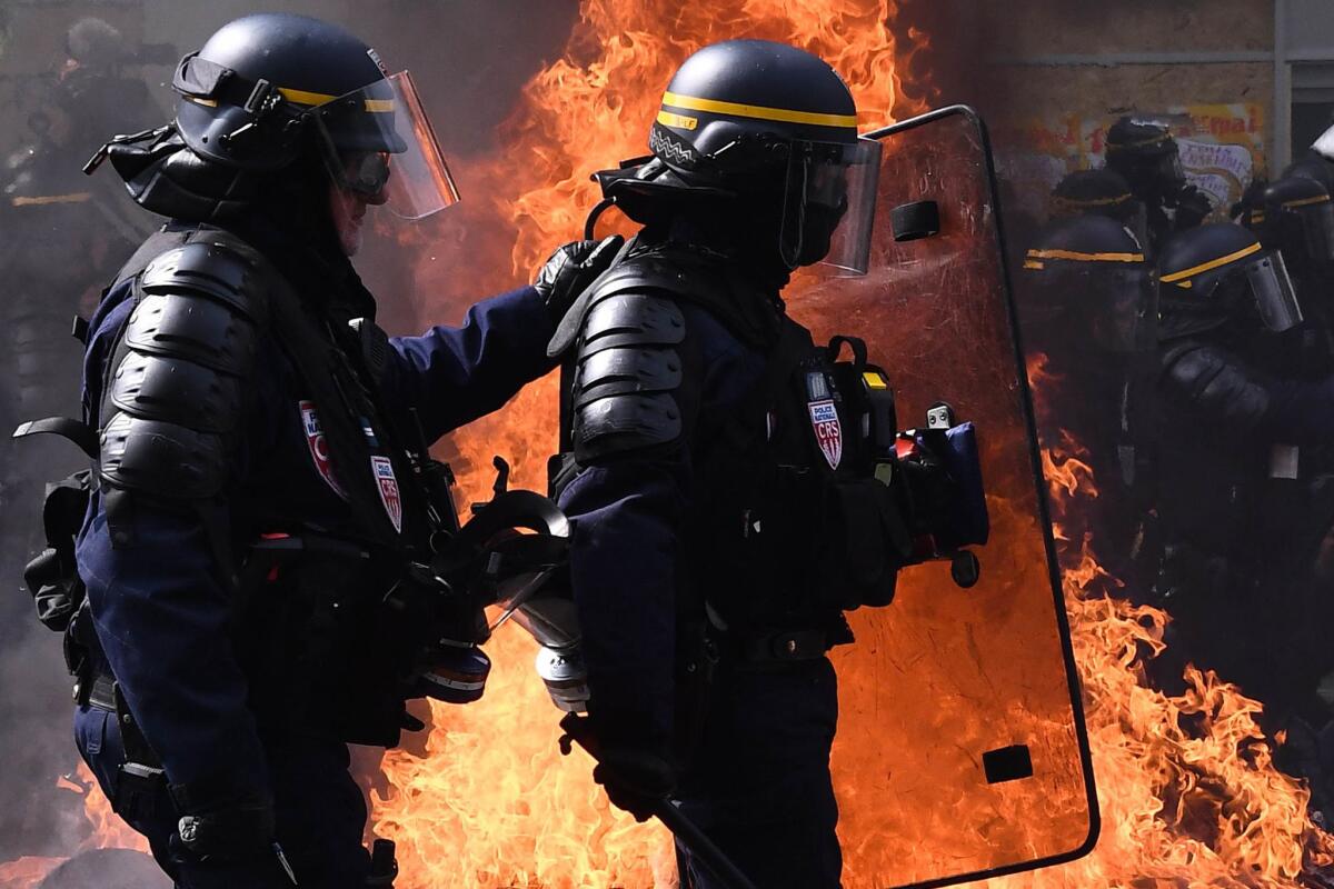 Anti-riot police walk past a burning barricade as they clash with protesters during a May Day demonstration in Paris. (ANNE-CHRISTINE POUJOULAT / AFP / Getty Images)