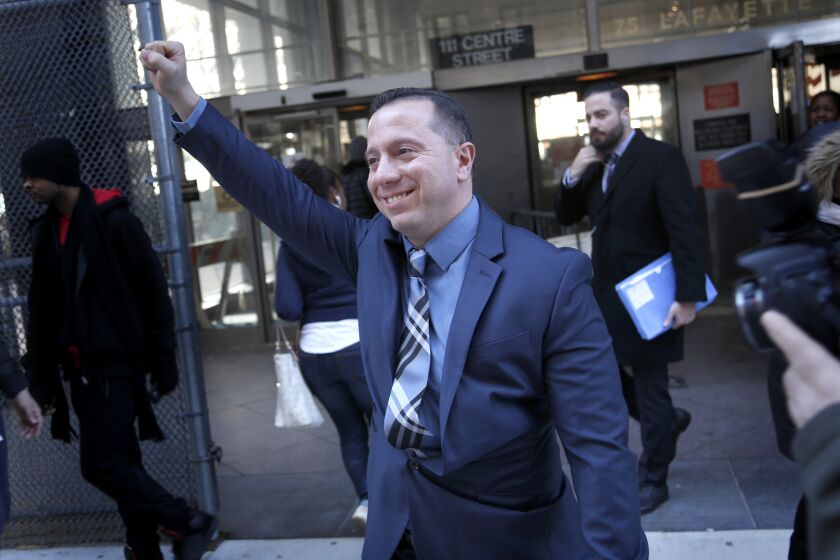 FILE - Johnny Hincapie raises his fist as he leaves the courthouse in New York, Jan. 25, 2017. Attorneys for Hincapie confirmed Friday, Dec. 2, 2022, that Hincapie, a man who was freed in 2015 after spending a quarter-century in prison for an infamous tourist killing, will receive nearly $18 million in legal settlements from the city and state of New York. (AP Photo/Seth Wenig, File)