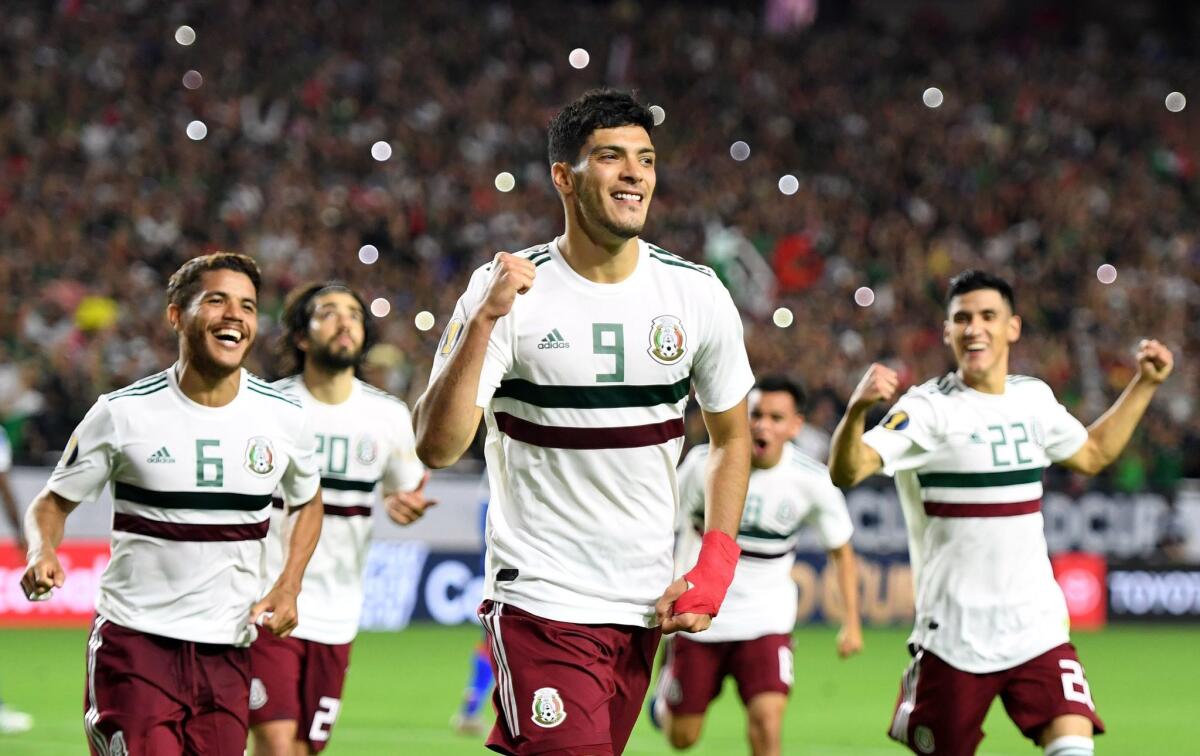 Mexico's forward Raul Jimenez (C) celebrates with teammates after scoring a goal in overtime during the 2019 Concacaf Gold Cup semifinal football match between Mexico and Haiti on July 2, 2019 in Glendale, Arizona.