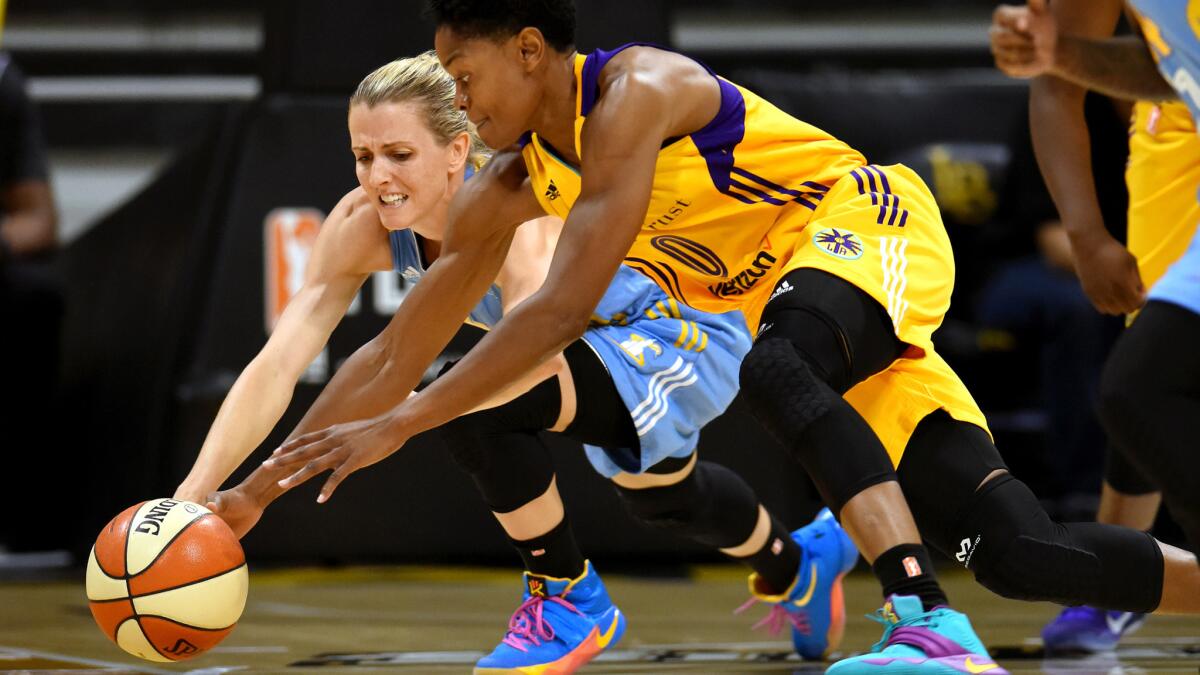 Sparks guard Alana Beard (0) tries to beat Sky guard Allie Quigley to a loose ball during the first half of Game 1.